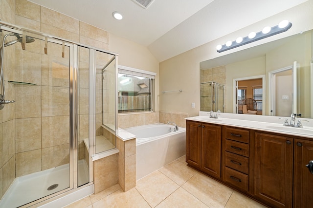 bathroom with tile patterned flooring, lofted ceiling, vanity, and plus walk in shower