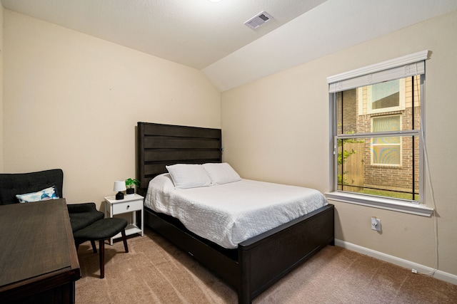 carpeted bedroom featuring lofted ceiling