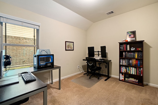 carpeted office space featuring vaulted ceiling