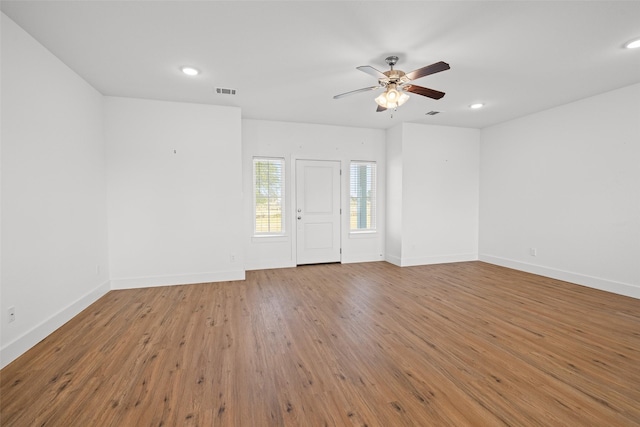 empty room featuring ceiling fan and hardwood / wood-style floors