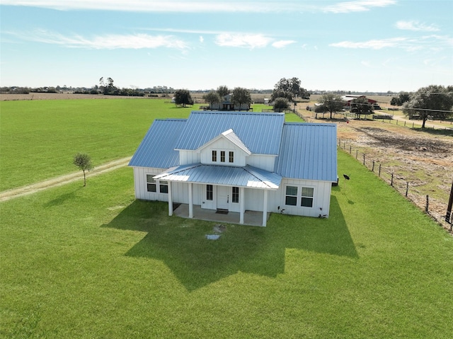 birds eye view of property with a rural view