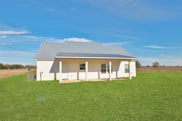 back of house with a yard and central AC unit