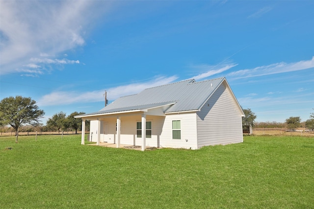 back of house with a lawn