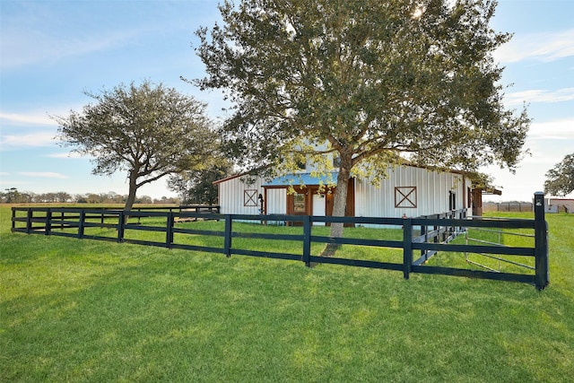 view of yard featuring a rural view and an outdoor structure