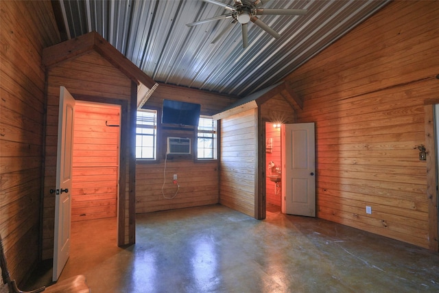 unfurnished bedroom with ceiling fan, wooden walls, and high vaulted ceiling