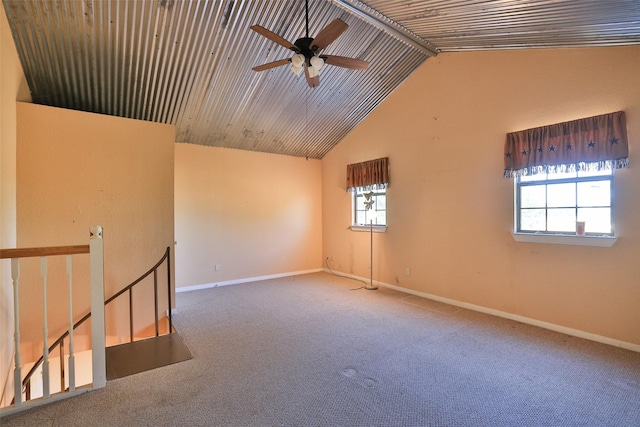 carpeted spare room with high vaulted ceiling and ceiling fan