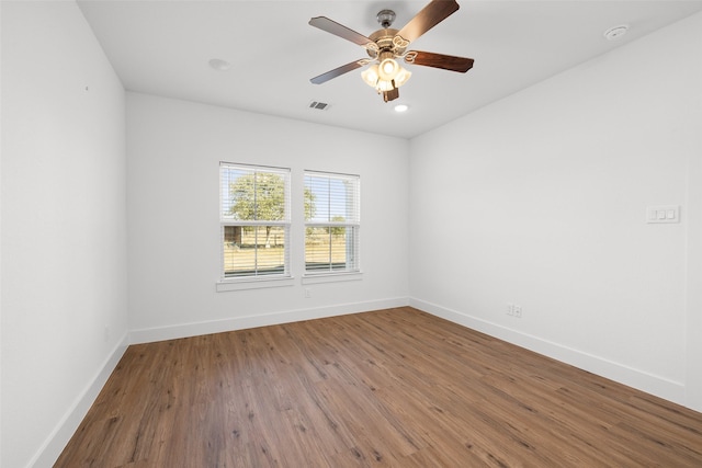 spare room with wood-type flooring and ceiling fan