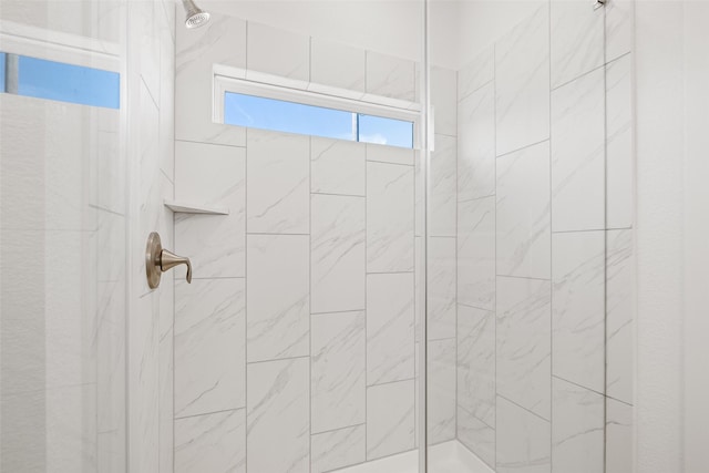 bathroom with a tile shower