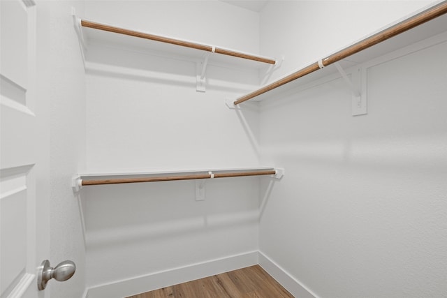 walk in closet with hardwood / wood-style floors