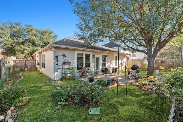 rear view of house featuring a lawn and a patio area