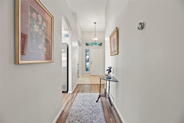 hallway with light hardwood / wood-style floors