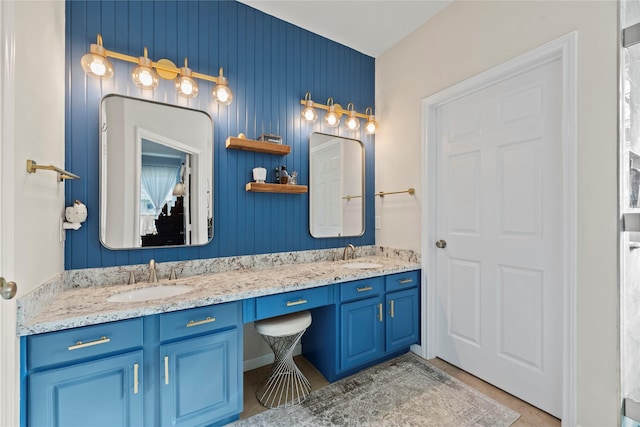 bathroom featuring vanity and wood walls