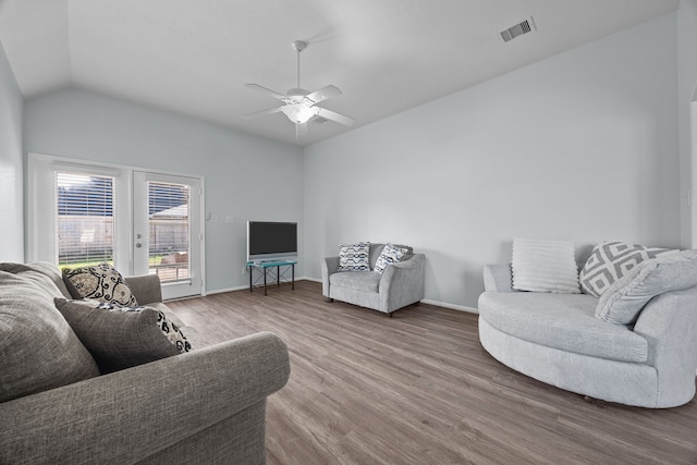 living room featuring wood-type flooring, vaulted ceiling, and ceiling fan