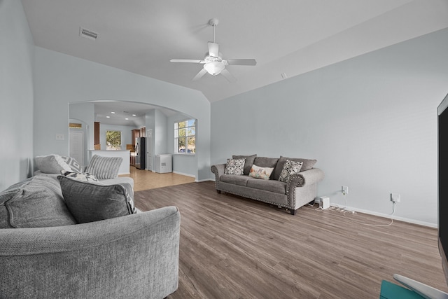 living room with hardwood / wood-style flooring, ceiling fan, and lofted ceiling