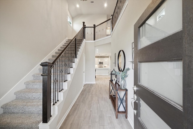 foyer entrance with a towering ceiling