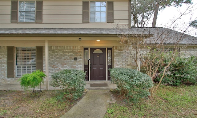 view of exterior entry with a porch