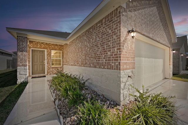 exterior entry at dusk with a garage