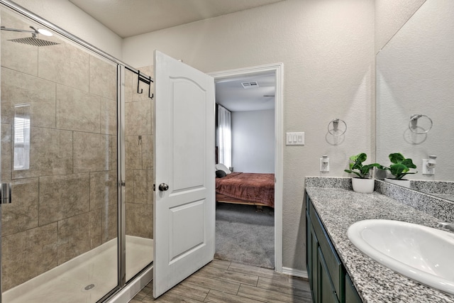 bathroom with vanity and a shower with door