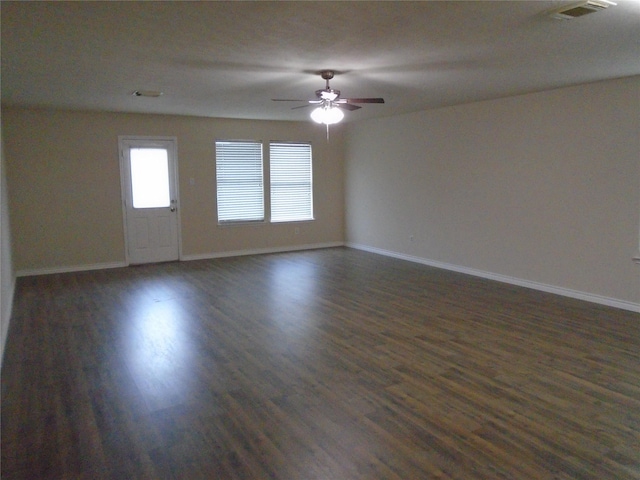 empty room with dark hardwood / wood-style flooring and ceiling fan