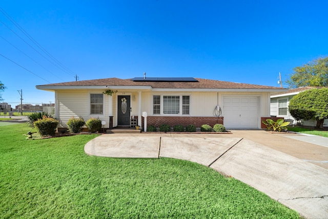 ranch-style home featuring a front lawn, a garage, and solar panels