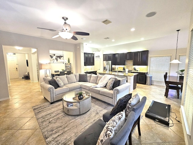 tiled living room featuring ceiling fan