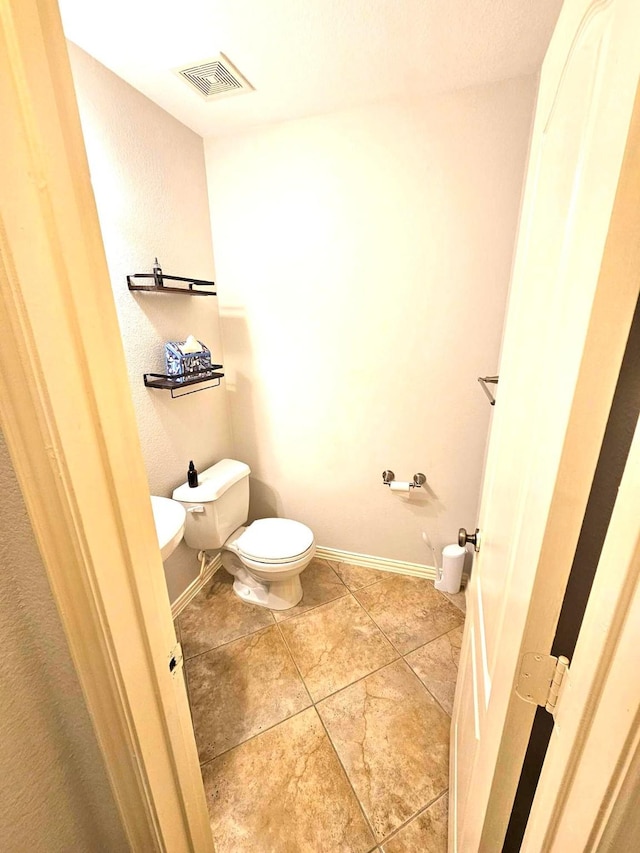 bathroom featuring tile patterned floors and toilet