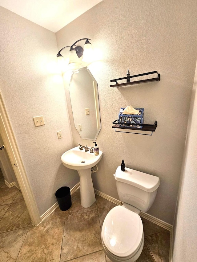 bathroom featuring tile patterned floors and toilet