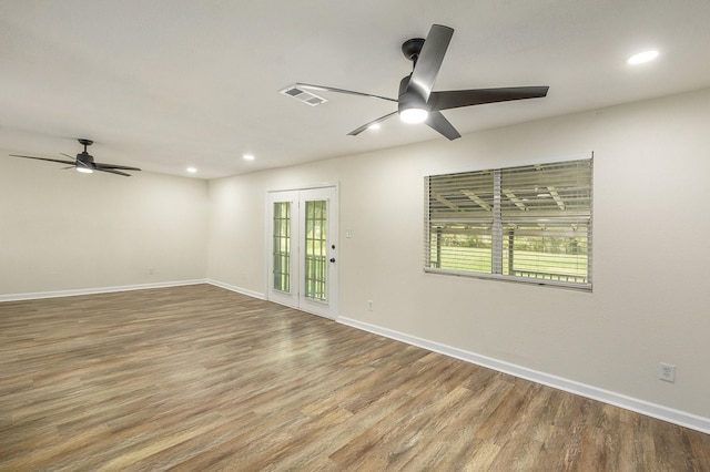 unfurnished room featuring ceiling fan and hardwood / wood-style flooring