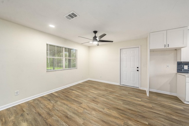 unfurnished bedroom with ceiling fan, dark hardwood / wood-style flooring, and a closet