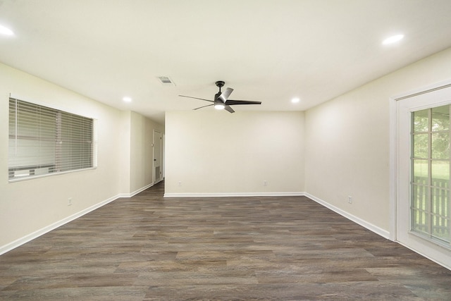 empty room with ceiling fan and dark hardwood / wood-style flooring