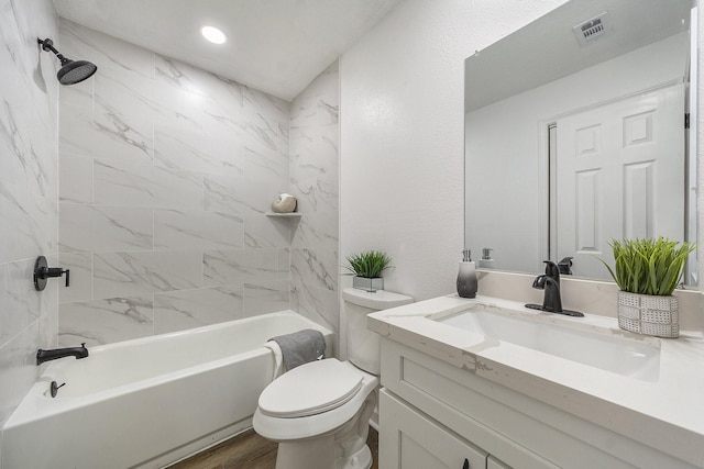 full bathroom with wood-type flooring, vanity, toilet, and tiled shower / bath