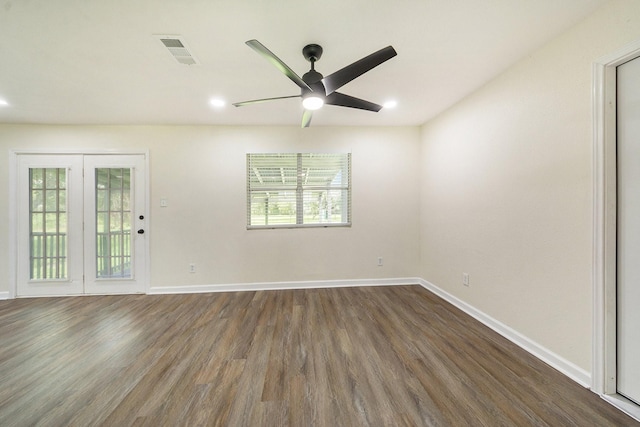 empty room with dark hardwood / wood-style flooring and ceiling fan