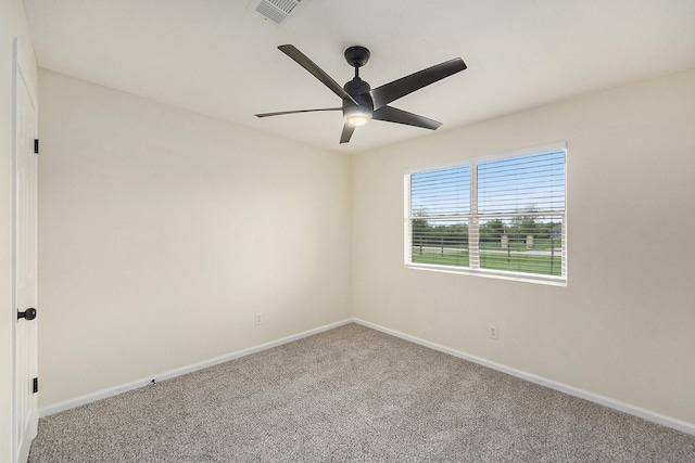 carpeted empty room featuring ceiling fan