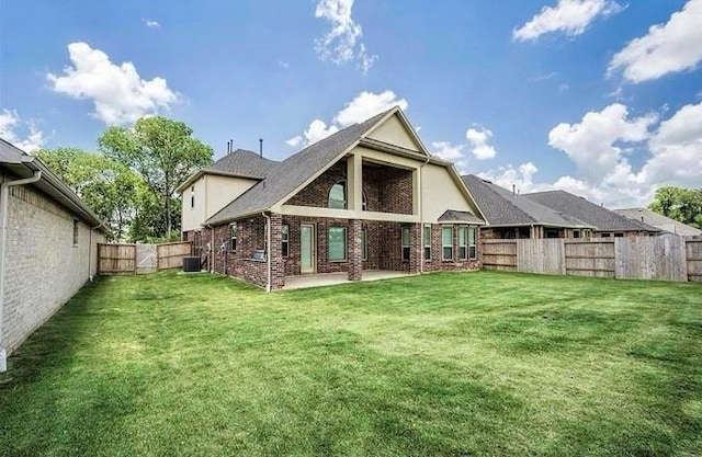 rear view of house featuring a lawn, central AC, and a patio