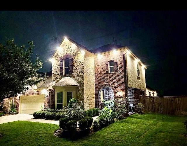 view of front of property with a lawn and a garage