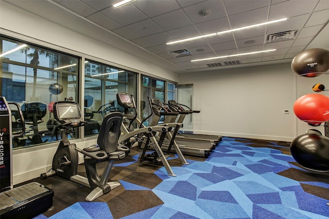 exercise room with a drop ceiling