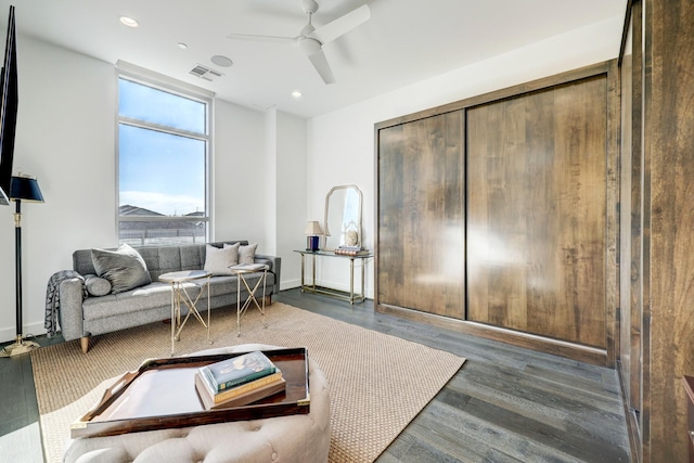 living room with ceiling fan and dark hardwood / wood-style floors