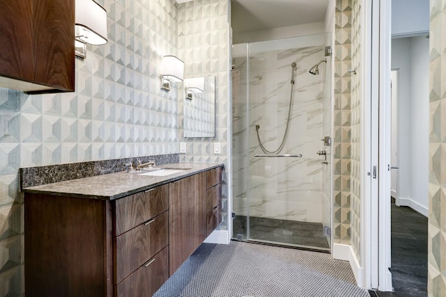 bathroom featuring vanity and an enclosed shower