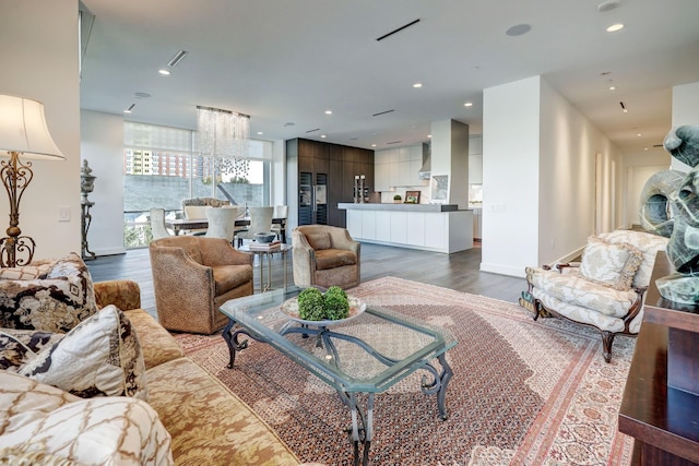 living room with a notable chandelier and dark wood-type flooring