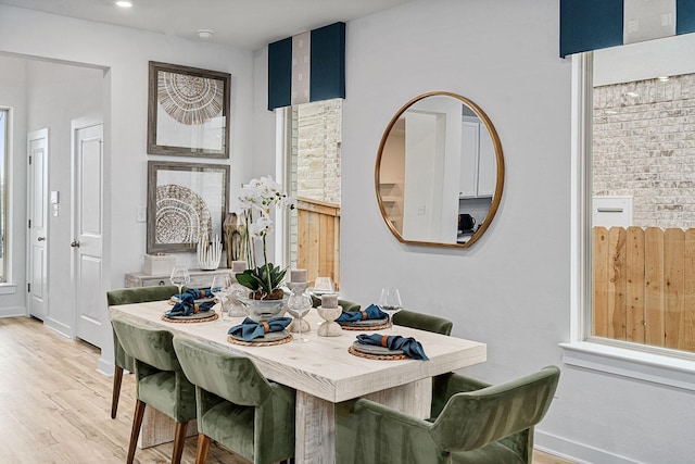 dining space with light hardwood / wood-style flooring