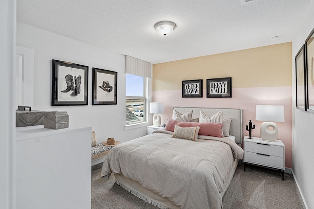 bedroom featuring carpet and a textured ceiling