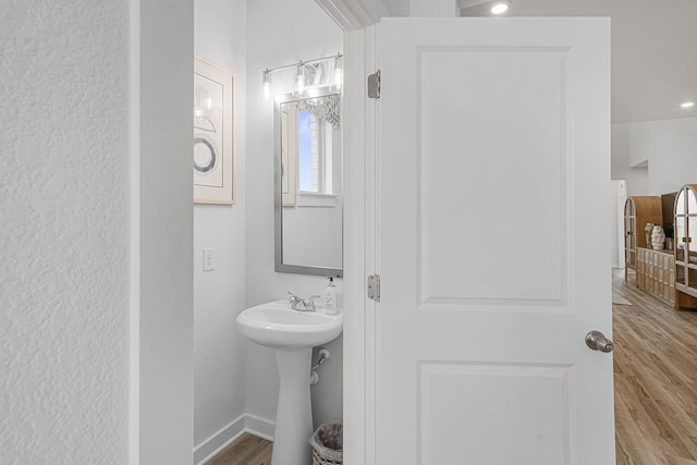 bathroom with hardwood / wood-style floors and sink