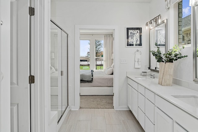 bathroom with vanity and a shower with shower door