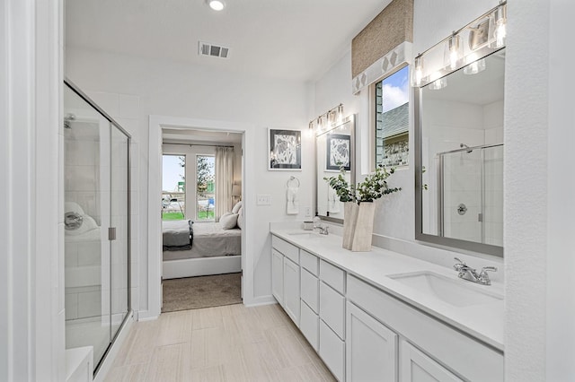 bathroom featuring vanity and an enclosed shower