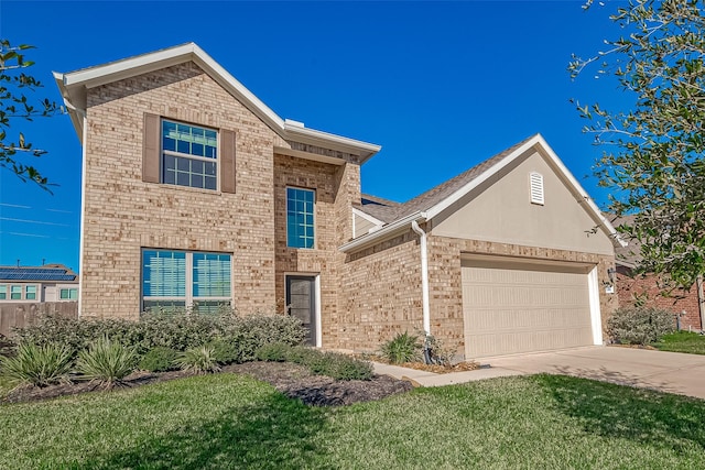 view of front property featuring a front yard and a garage