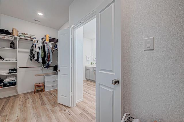 spacious closet featuring light hardwood / wood-style floors