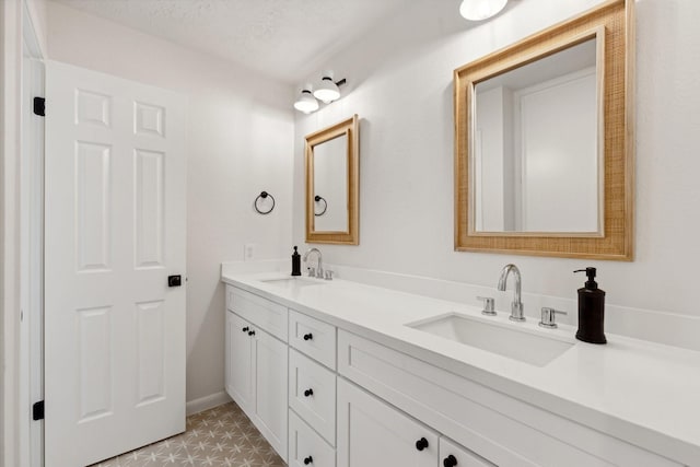 bathroom with vanity and a textured ceiling