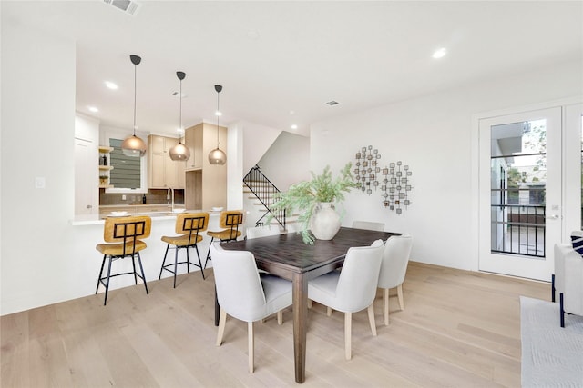 dining space featuring light hardwood / wood-style flooring and sink