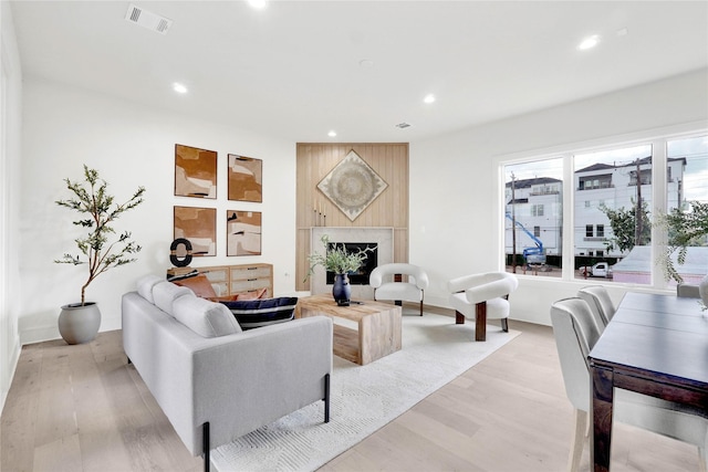 living room featuring light hardwood / wood-style floors and a fireplace