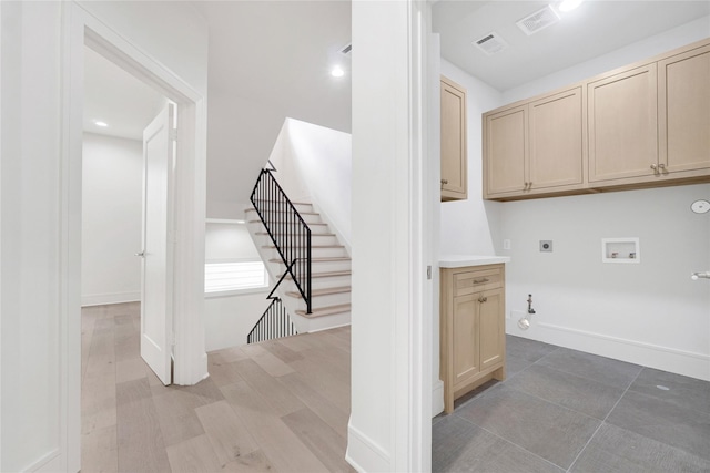 clothes washing area featuring hookup for an electric dryer, washer hookup, gas dryer hookup, and cabinets